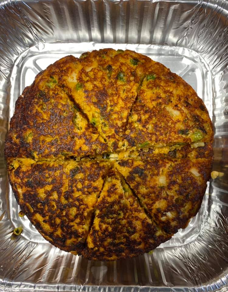 Freshly baked Gujarati handvo cut into wedges